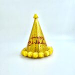 כובע Happy Birthday זהב עם פונפונים